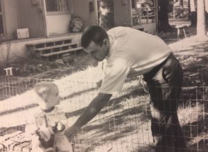 Tom Harris, a neighbor who was in law school, with our son, Bo. In the background you can see the porches of four apartments.