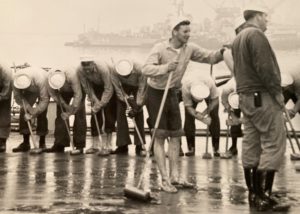 Sailors holystoning the decks of USS Los Angeles.